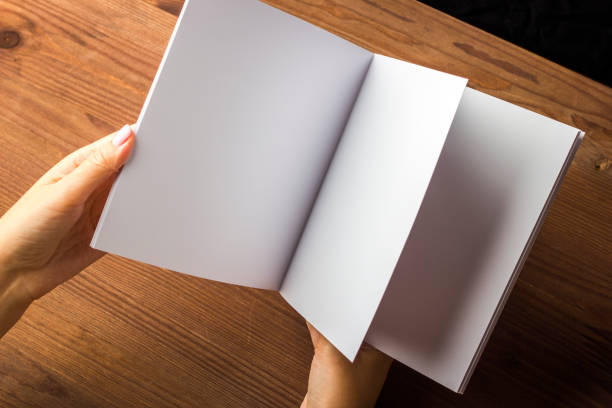 istock Empty white paper for notes, notebook, diary, booklet, organizer in hand on a wooden table. 861493152