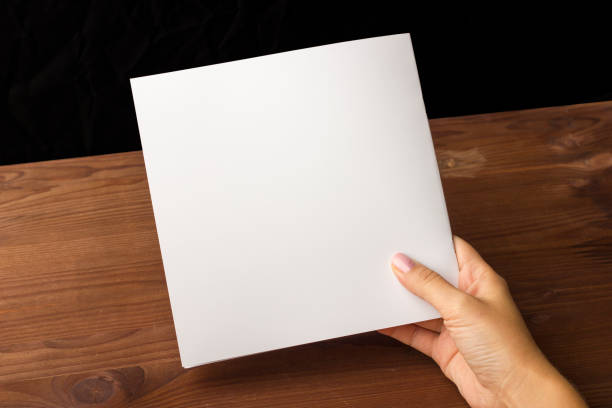 istock Empty white paper for notes, notebook, diary, booklet, organizer in hand on a wooden table. 861493162