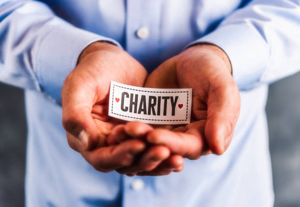 istock Male hands holding sign reading charity 861493306