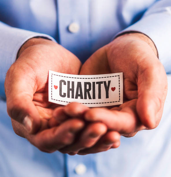 istock Male hands holding sign reading charity 861493332