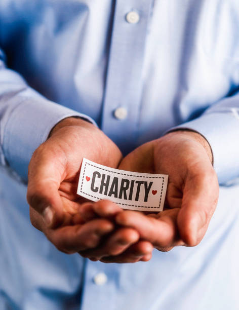 istock Male hands holding sign reading charity 861493354