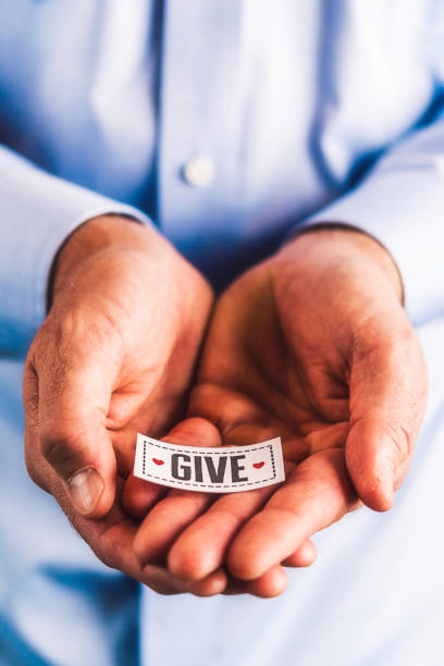istock Male hands holding sign reading give 861493356