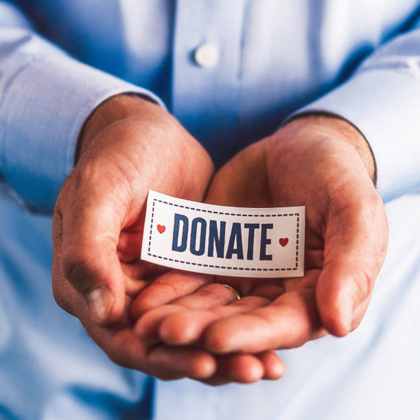 istock Male hands holding sign reading donate 861493438