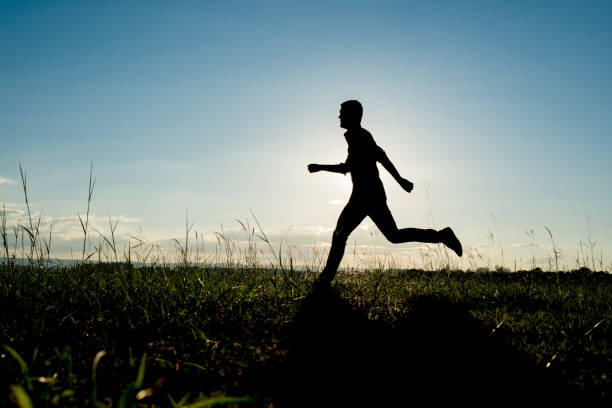 istock Silhouette of the running man at sunset background. 861499804