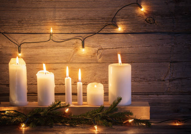 istock Christmas candles on wooden background 861505028