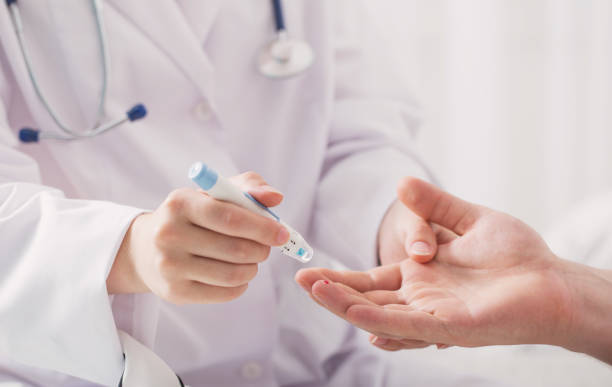 istock doctor measuring blood sugar young men 861505108