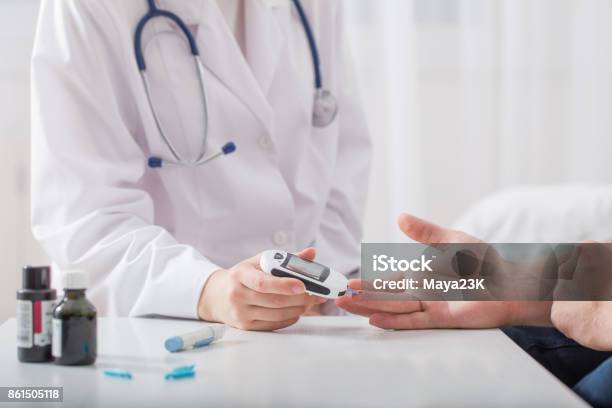 Doctor Measuring Blood Sugar Young Men Stock Photo - Download Image Now - Diabetes, Doctor, Glucometer