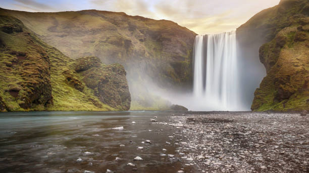 istock Long exposure of popular Skogafoss waterfall in southern Iceland, a classically-shaped waterfall set among steep cliffs with lush greenery. 861518008