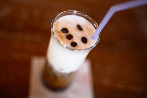 Iced coffee with cream and coffee beans