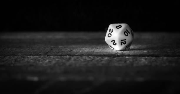 Gaming dice on a wooden table top being rolled out of a bag Gaming dice on a wooden table top being rolled out of a bag shot in natural light with subdued wood grain colors as background developing 8 stock pictures, royalty-free photos & images