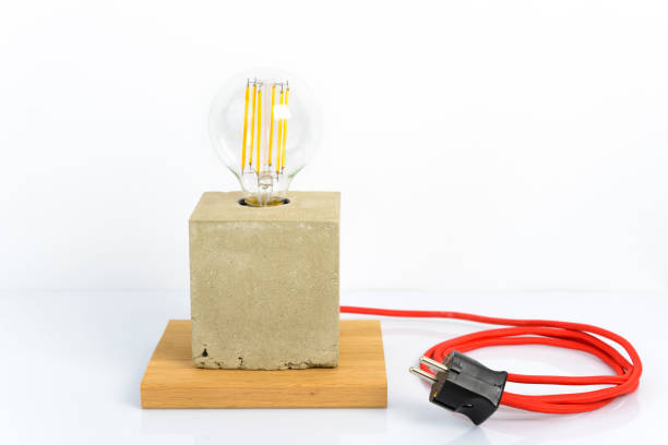 istock Concrete lamp with modern led light bulb and red power cord 861530258