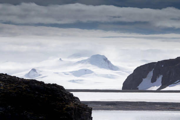 istock Wind and clouds sweep over this mountain in Antarctica. 861530510