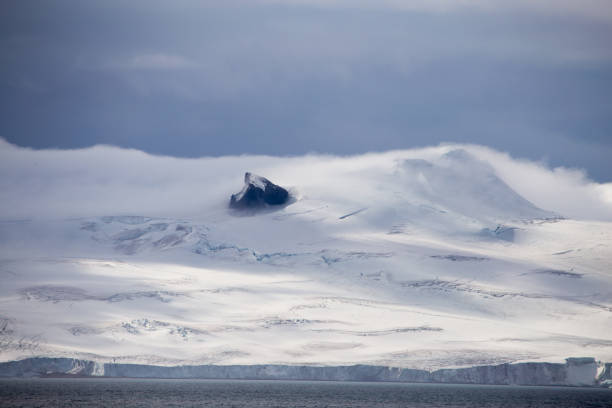 istock Wind and clouds sweep over this mountain in Antarctica. 861530532