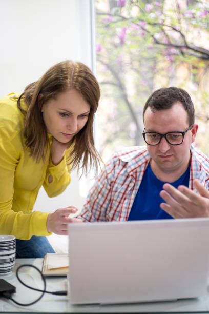 istock Two entrepreneurs sitting together working in an office desk comparing documents 861537776