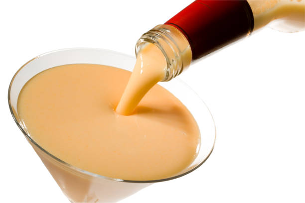 egg liqueur pour out in glass, isolated on white, clipping path included