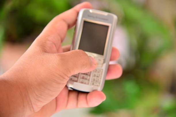 istock Close up hand on blurred small mobile.Selective focus at hand on. 861538598