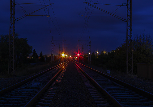 Railway track in night with red and orange light