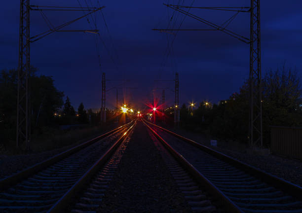 Railway track in night with red and orange light stock photo