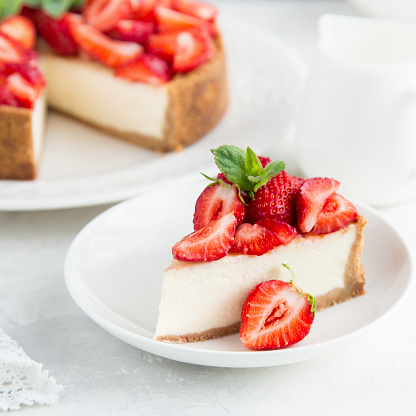 slice of strawberry cheesecake on white background, selective focus, square image