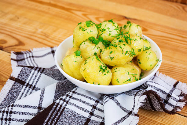 Young potatoes on wooden background