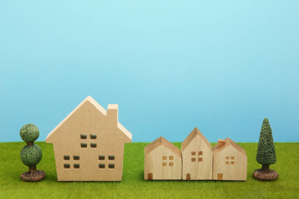 istock Houses on green grass over blue sky. 861545528