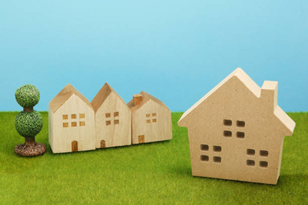 istock Houses on green grass over blue sky. 861545562