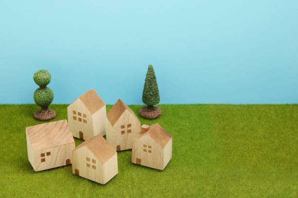 istock Houses on green grass over blue sky. 861545564