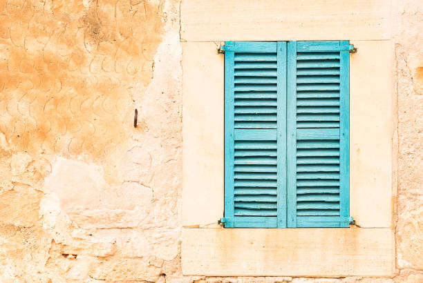 Blue window shutters and old wall.