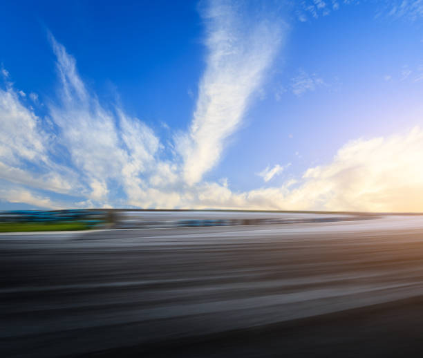 istock Motion blur asphalt road circuit and sky clouds at sunset 861547060