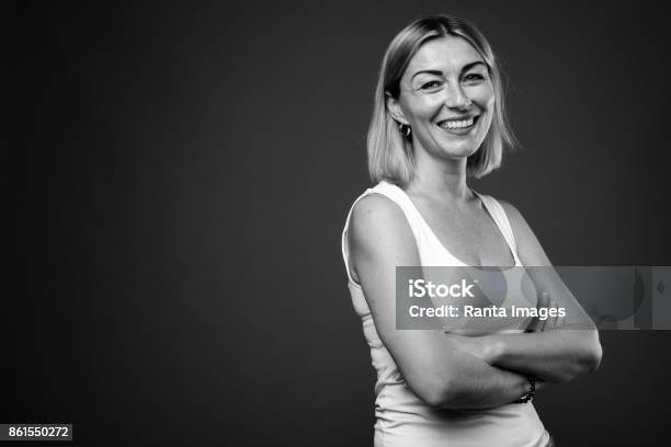 Studio Shot Of Mature Woman With Short Hair Wearing Tank Top In Black And White Stock Photo - Download Image Now