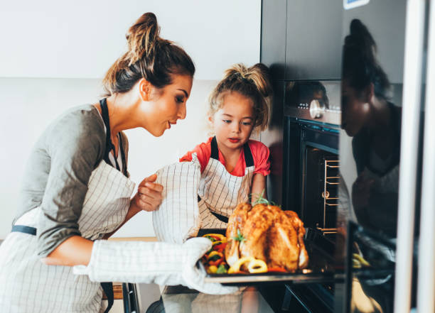 istock Mother taking the dinner out of the oven 861552744