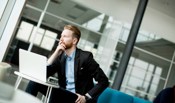 istock Redhead young businessman working  on laptop or notebook 861552832