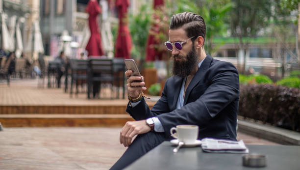 istock Urban man sitting in cafe and texting 861553416