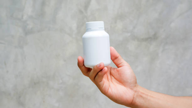 istock Man holding a white medicine bowl on gray background. 861556494