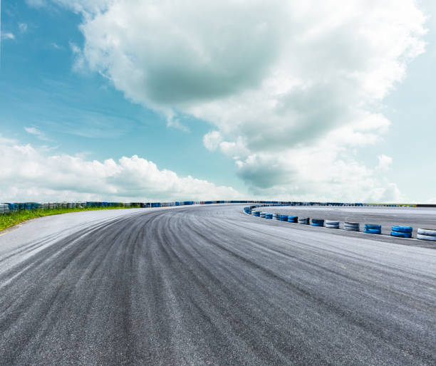 istock Asphalt road circuit and sky clouds with car tire brake 861560892