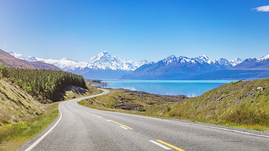 Summer Panorama of the road towards the famous Mount Cook along the turquoise Lake Pukaki. South Island, Canterbury, Mackenzie Basin, Mount Cook, Lake Pukaki, New Zealand