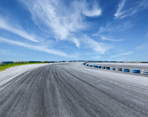istock Asphalt road circuit and sky clouds with car tire brake 861568942