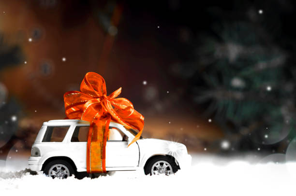small car with a decorative bow in snow