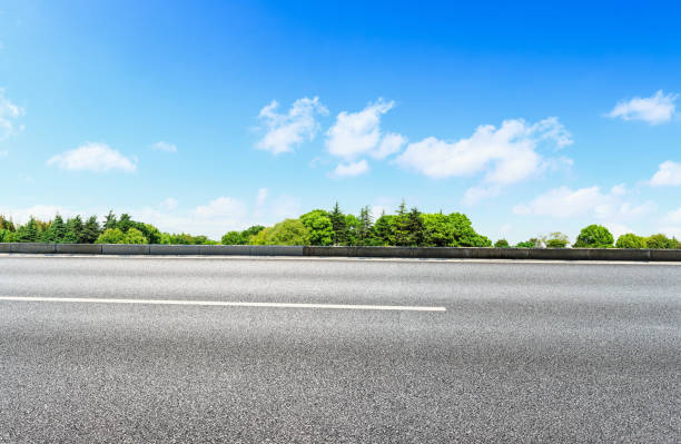 istock Asphalt road and green forest in the blue sky 861579330