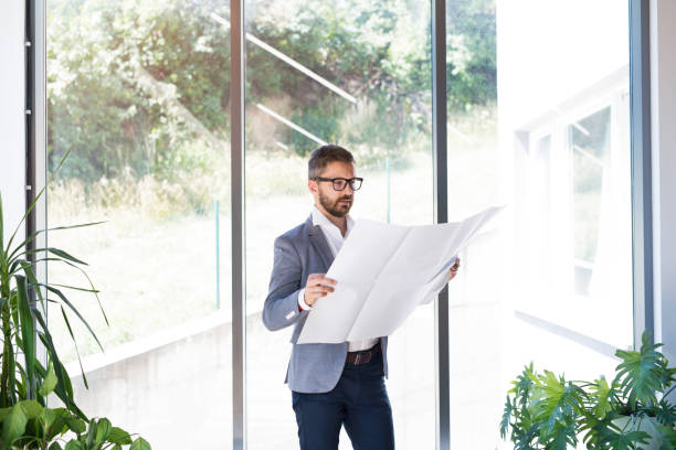 istock Young businessman in his office studying plans. 861579682