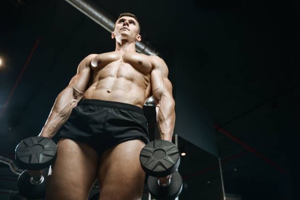 istock Handsome model young man working out in gym 861583988