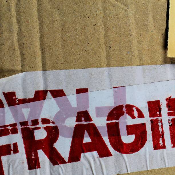 istock Adhesive tape with FRAGILE word on old eroded cardboard 861588202