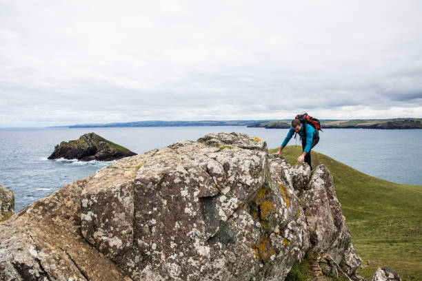 istock Solo traveler exploring the rocky coastline in Cornwall, UK 861607718