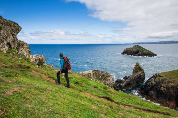 istock Solo traveler exploring the rocky coastline in Cornwall, UK 861607734