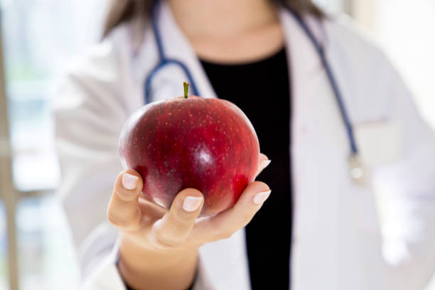 istock Female doctor holding red apple 861610914