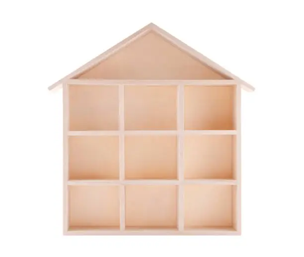 Photo of Wooden house shaped shelf isolated on white