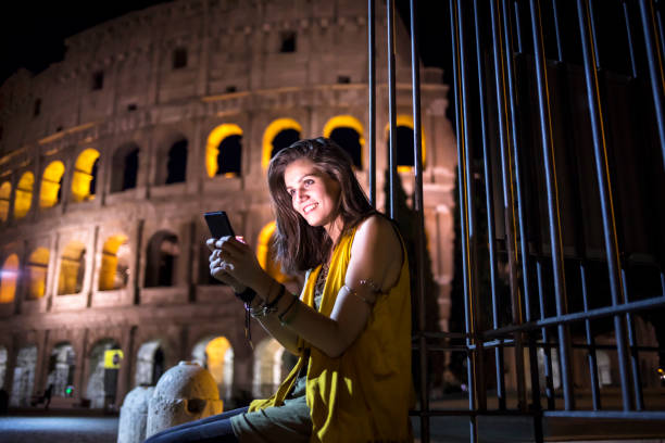 istock Smiling young woman using smart phone in Rome 861618334