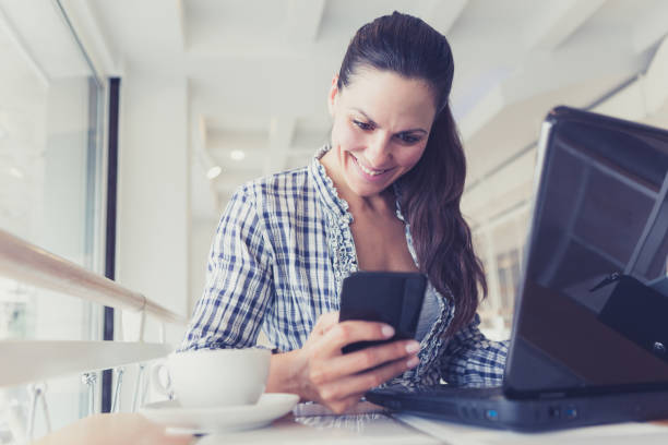 istock Young Woman freelancer using the technology laptop and smart phone in cafe. Creative Startup and entrepreneur business concept 861618972