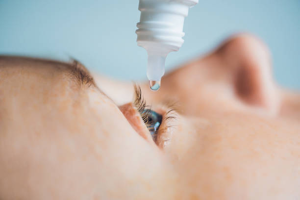 istock Closeup of eyedropper putting liquid into open eye 861619618