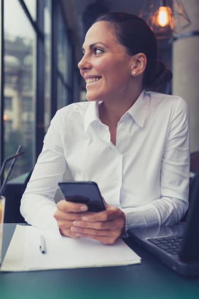 istock Beautiful young businesswoman using smart phone in cafe 861625312